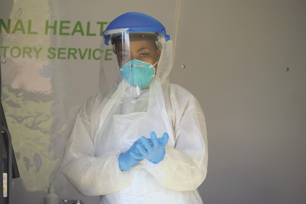 A health worker prepares in a mobile NHLS testing lab at a Diepsloot COVID-19 screening and testing site at Diepsloot Sarafina Park (1).jpg