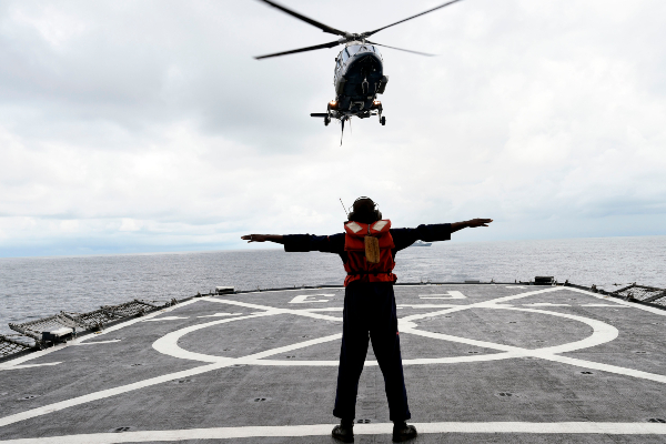 A helicopter lands on board a ship during a five day military exercise in 2019jpg