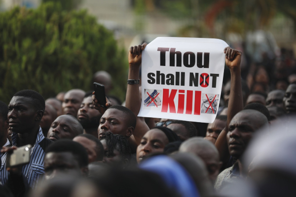 Christian faithful hold signs as they march on the streets of Abuja during a prayer and penance for peace and security in Nigeria.jpg
