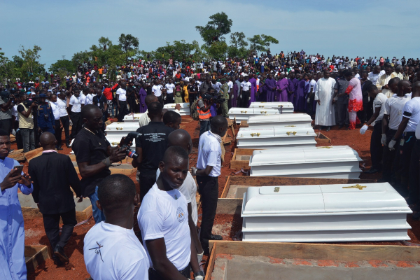 Coffins are prepared for burial during a funeral service for 17 worshippers and two priests, who were allegedly killed by Fulani herdsmen.jpg