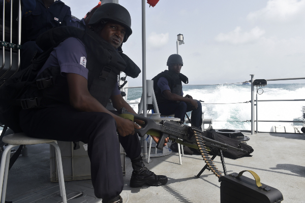 Nigerian naval members sit in a vessel during Obangame Express a multi national maritime exercise i