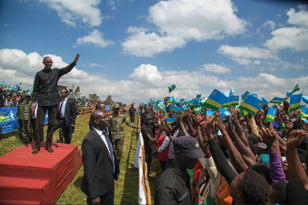 Rwandan President Paul Kagame L waves during a celebration of the liberation anniversary in Muhanga Rwanda on July 4 2018